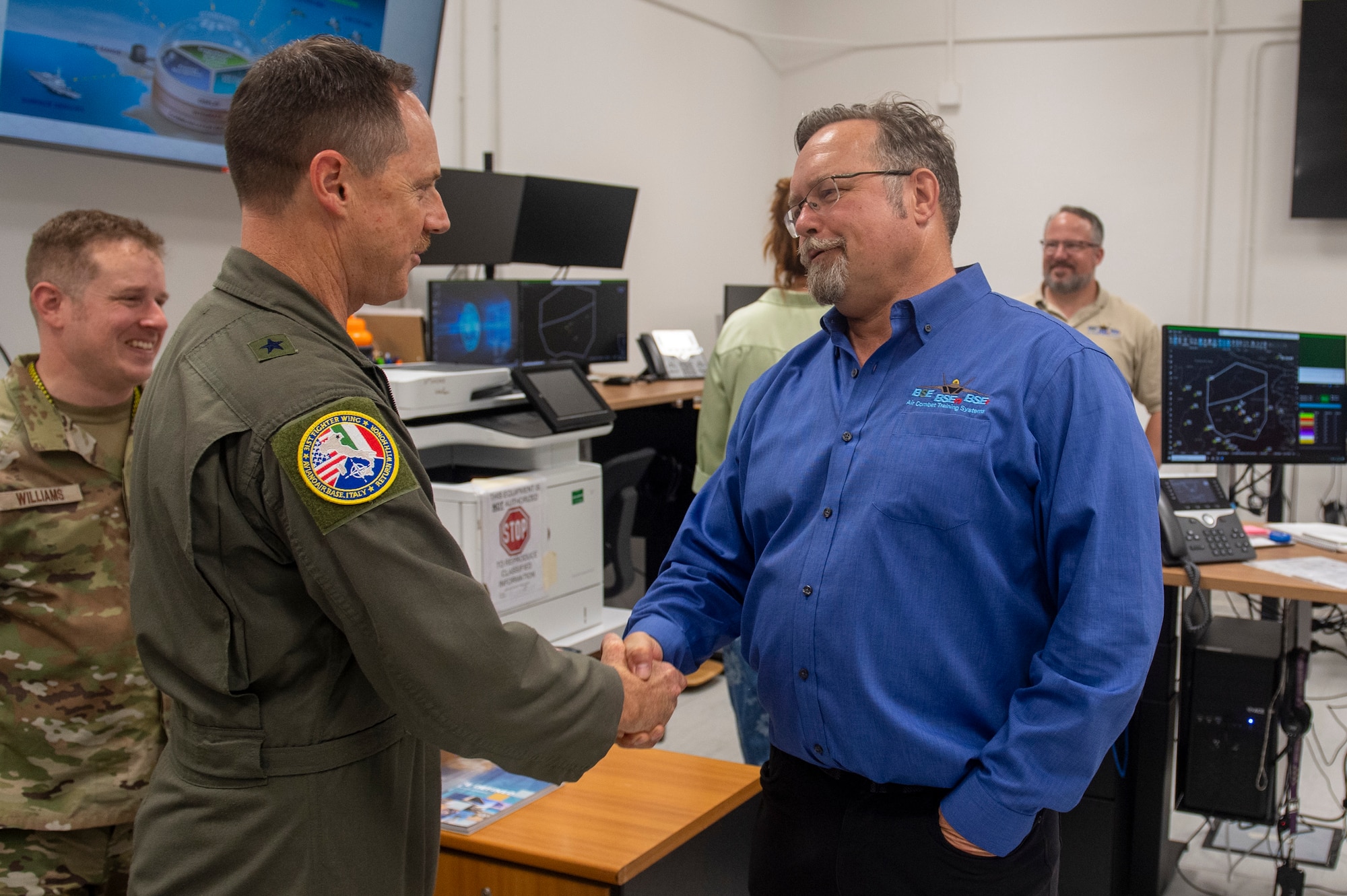 Two men shake hands