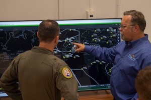 A man points at a screen