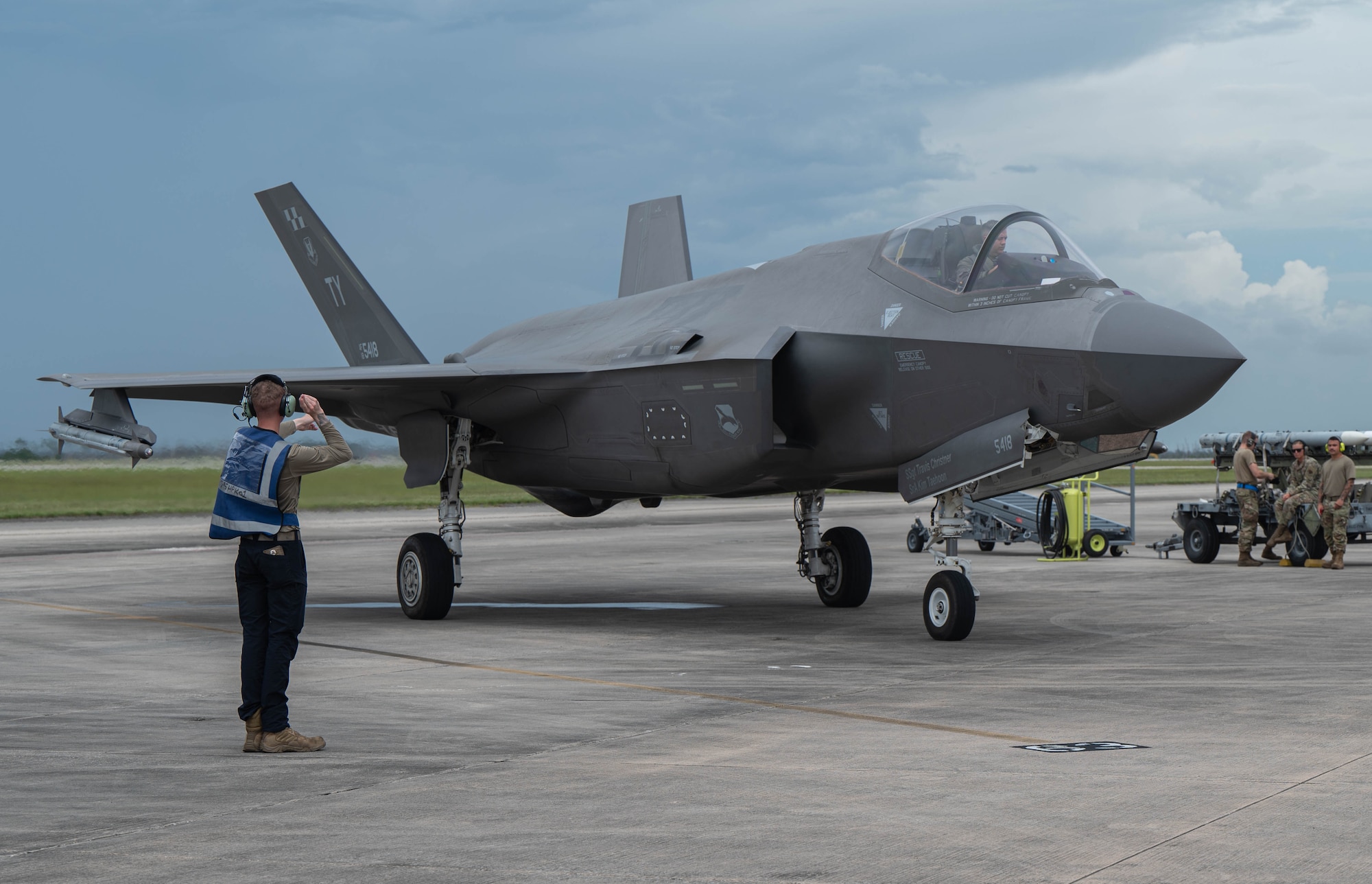 Picture of maintainer marshalling an F-35A