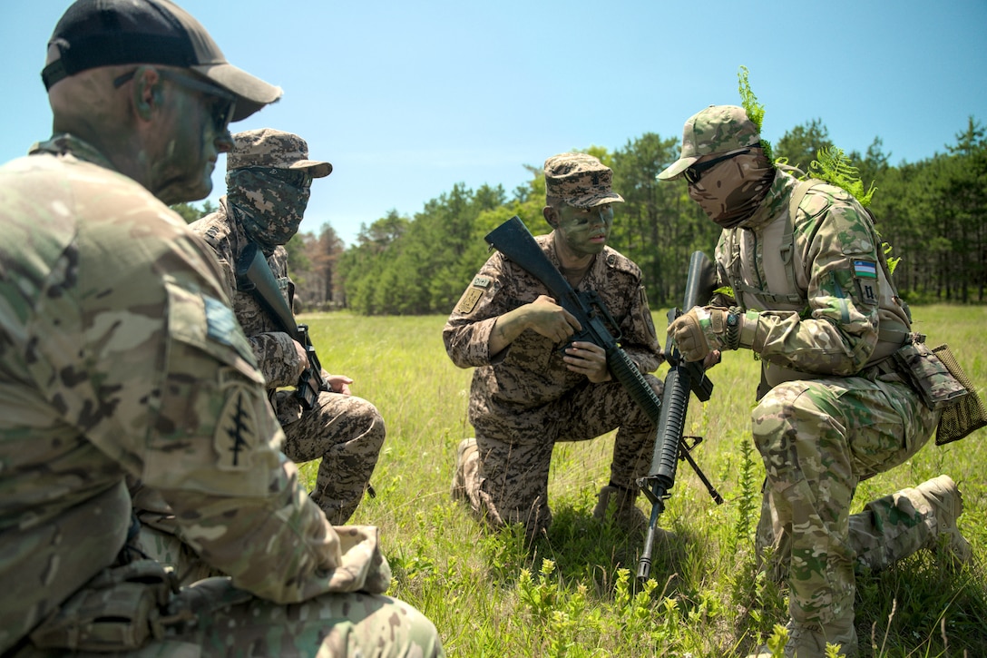 To close out the first week of Regional Cooperation 25, MA Army National Guard Capt. Christian Carter of 51st Troop Command, with the aid of Green Berets and Civil Affairs Soldiers mobilized from 5th Special Forces Group and linguists assigned to 300th Military Intelligence Brigade, led camouflage and patrol training as part of Regional Cooperation 25.

As Regional Cooperation advances, each field training exercise portion builds up participants’ skills for a culminating exercise. (U.S. Army photo by Sgt. Justin Leva)
