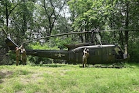 Soldiers from the 2-104th General Support Aviation Battalion, 28th Expeditionary Combat Aviation Brigade prepare a decommissioned UH-1 “Huey” helicopter to be air-lifted from the top of a mountain near Fort Indiantown Gap, Pennsylvania, to the installation June 20, 2025. (Pennsylvania National Guard photo by Brad Rhen)