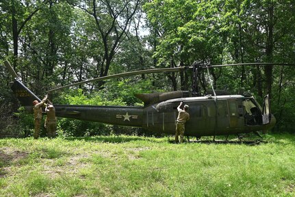 Soldiers from the 2-104th General Support Aviation Battalion, 28th Expeditionary Combat Aviation Brigade prepare a decommissioned UH-1 “Huey” helicopter to be air-lifted from the top of a mountain near Fort Indiantown Gap, Pennsylvania, to the installation June 20, 2025. (Pennsylvania National Guard photo by Brad Rhen)