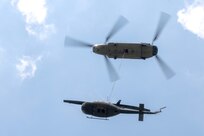 A CH-47 Chinook helicopter from 2-104th General Support Aviation Battalion, 28th Expeditionary Combat Aviation Brigade airlifts a decommissioned UH-1 “Huey” helicopter from the top Blue Mountain near Fort Indiantown Gap, Pennsylvania, to the installation on June 20, 2025. (Pennsylvania National Guard photo by Wayne V. Hall)
