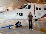 Miina Anvelt stands in front of the NRL Twin Otter aircraft assigned to the VXS-1 squadron at Naval Air Station Patuxent River during her SEAP internship on July, 19 2022.