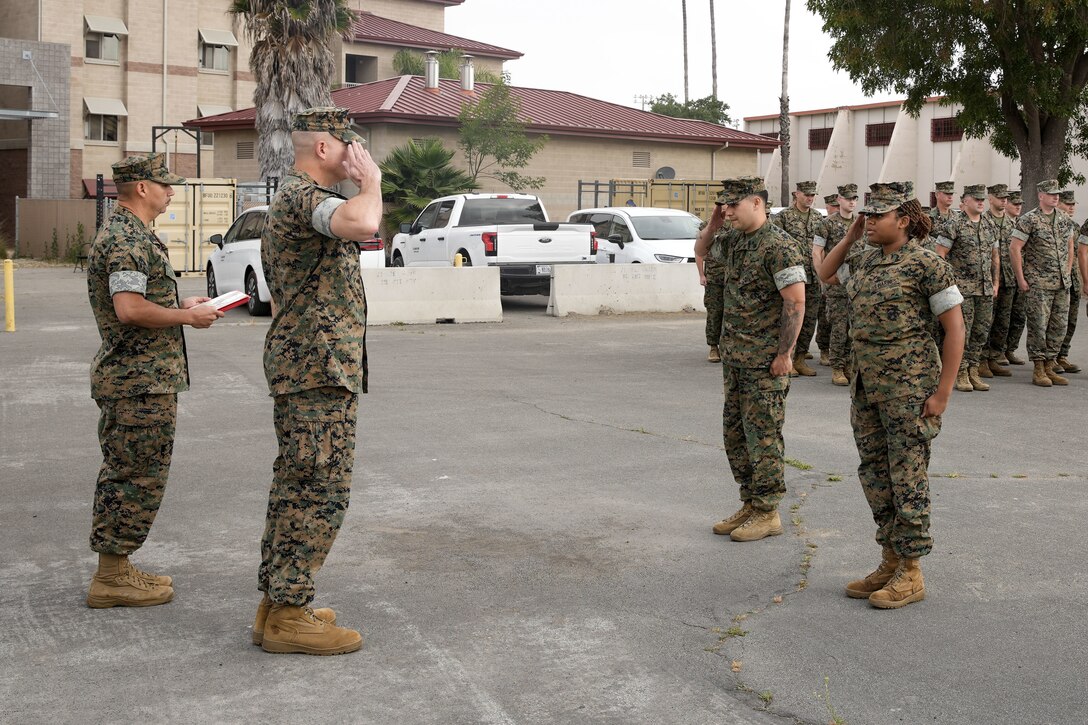 U.S. Marine Corps Lance Cpl. Yoomide Millar, right, intelligence specialist, and Staff Sgt. Lorenzo Monclova, fires and effects chief, both assigned to the 11th Marine Expeditionary Unit, I Marine Expeditionary Force, salute Col. Caleb Hyatt, commanding officer of the 11th MEU during an awards formation at Marine Corps Base Camp Pendleton, California, June 18, 2025.  As the Pride of the Pacific, the 11th MEU recognizes Marines who embody excellence in discipline, leadership, and warfighting readiness. (U.S. Marine Corps photo by Capt. Gerard Callan)