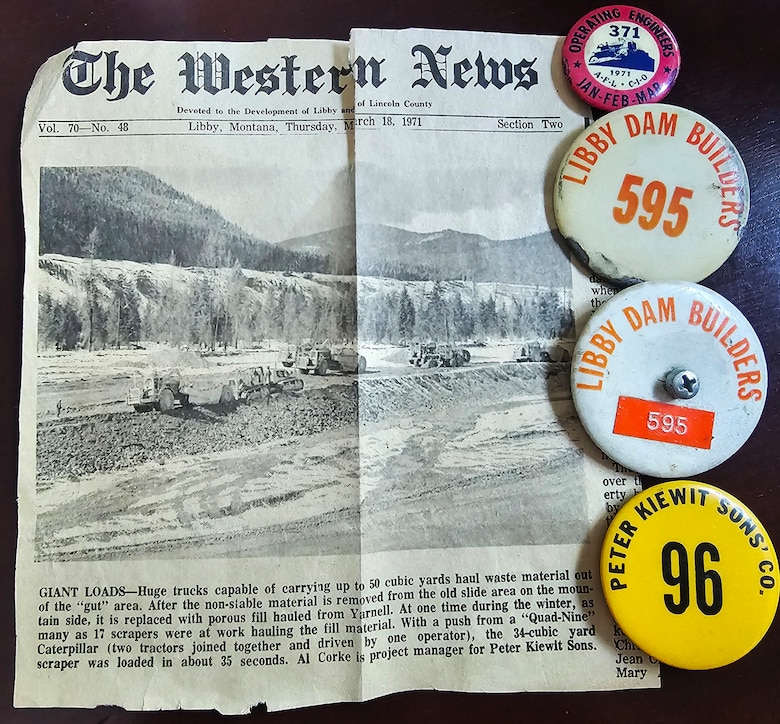 A spattering of Papa Whitmarsh's memorabilia, including ID buttons and news clipping from the Western News, Libby, Mont., from 1971 about the "Dirty Shame Rib," the name of a rock formation near Libby Dam. Both grandfathers of Natural Resource Manager Tana Wilson worked in construction of the dam. Libby Dam is a multi-purpose water resource development whose authorized purposes include flood reduction, hydropower, recreation, and environmental stewardship. (Photo courtesy Tana Wilson)