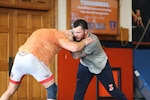 Spc. Joe Braunagel, right, trains during a wrestling session at the University of Illinois Urbana-Champaign, June 17, 2025. Braunagel, who serves in the Illinois Army National Guard, brings military discipline and mental toughness to the mat.