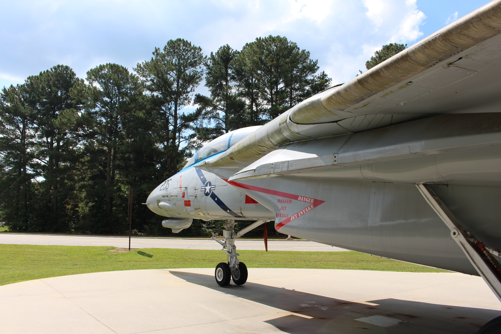 The static F-14 Tomcat on display outside the Main Gate at Arnold Air Force Base, Tenn., is dedicated to Navy Lt. Kara Hultgreen. Hultgreen was the first female carrier-based combat fighter pilot in the U.S. Navy and the first female fighter pilot in the U.S. military to die in a crash. She died Oct. 25, 1994, when the Tomcat she was piloting experienced engine failure on final approach to an aircraft carrier and crashed into the Pacific Ocean near San Diego, Calif. (U.S. Air Force photo by Kali Bradford)