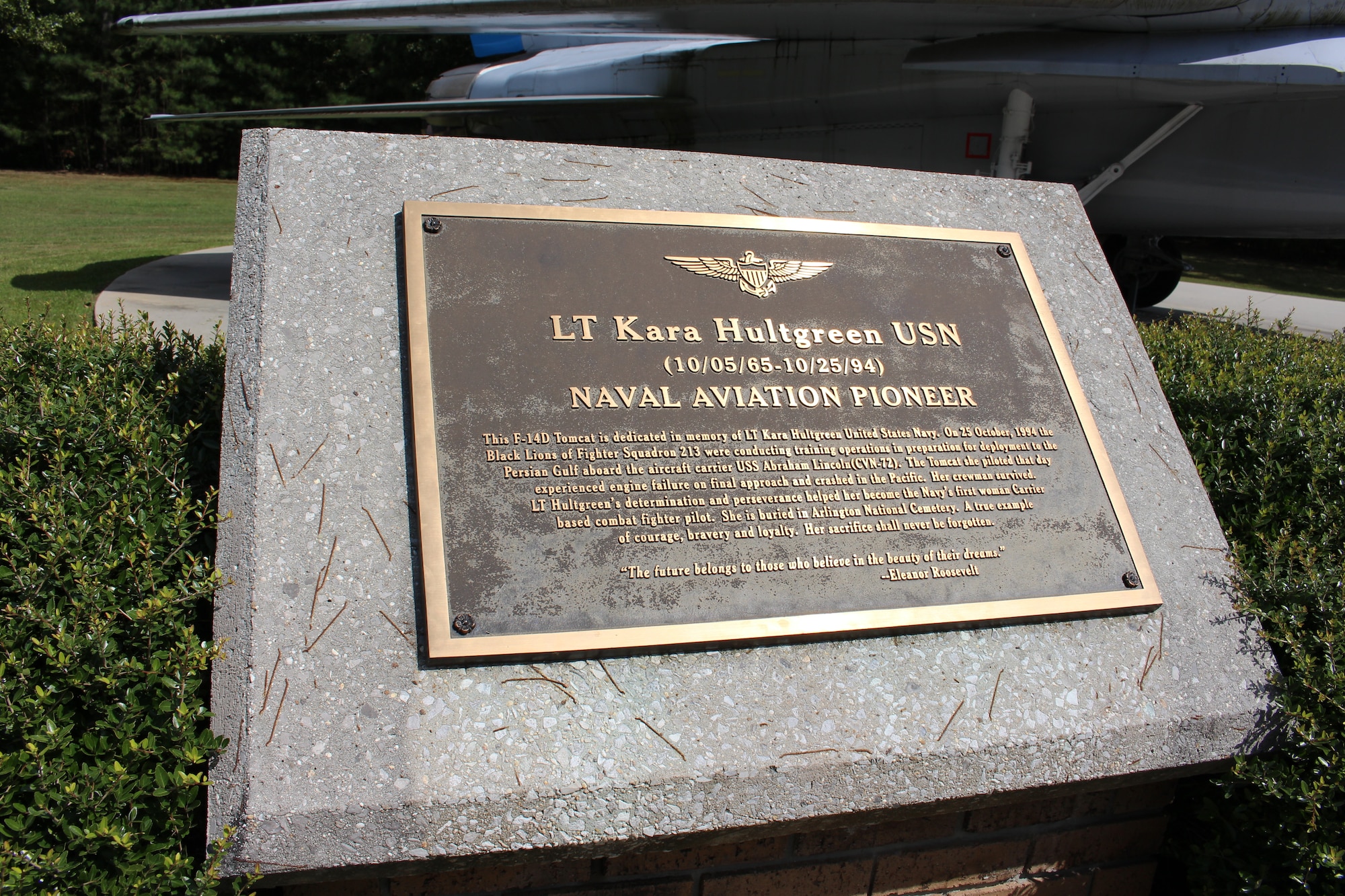 This plaque is located next to the static F-14 Tomcat on display outside the Main Gate at Arnold Air Force Base, Tenn. The display is dedicated to Navy Lt. Kara Hultgreen. Hultgreen was the first female carrier-based combat fighter pilot in the U.S. Navy and the first female fighter pilot in the U.S. military to die in a crash. She died Oct. 25, 1994, when the Tomcat she was piloting experienced engine failure on final approach to an aircraft carrier and crashed into the Pacific Ocean near San Diego, Calif. (U.S. Air Force photo by Kali Bradford)
