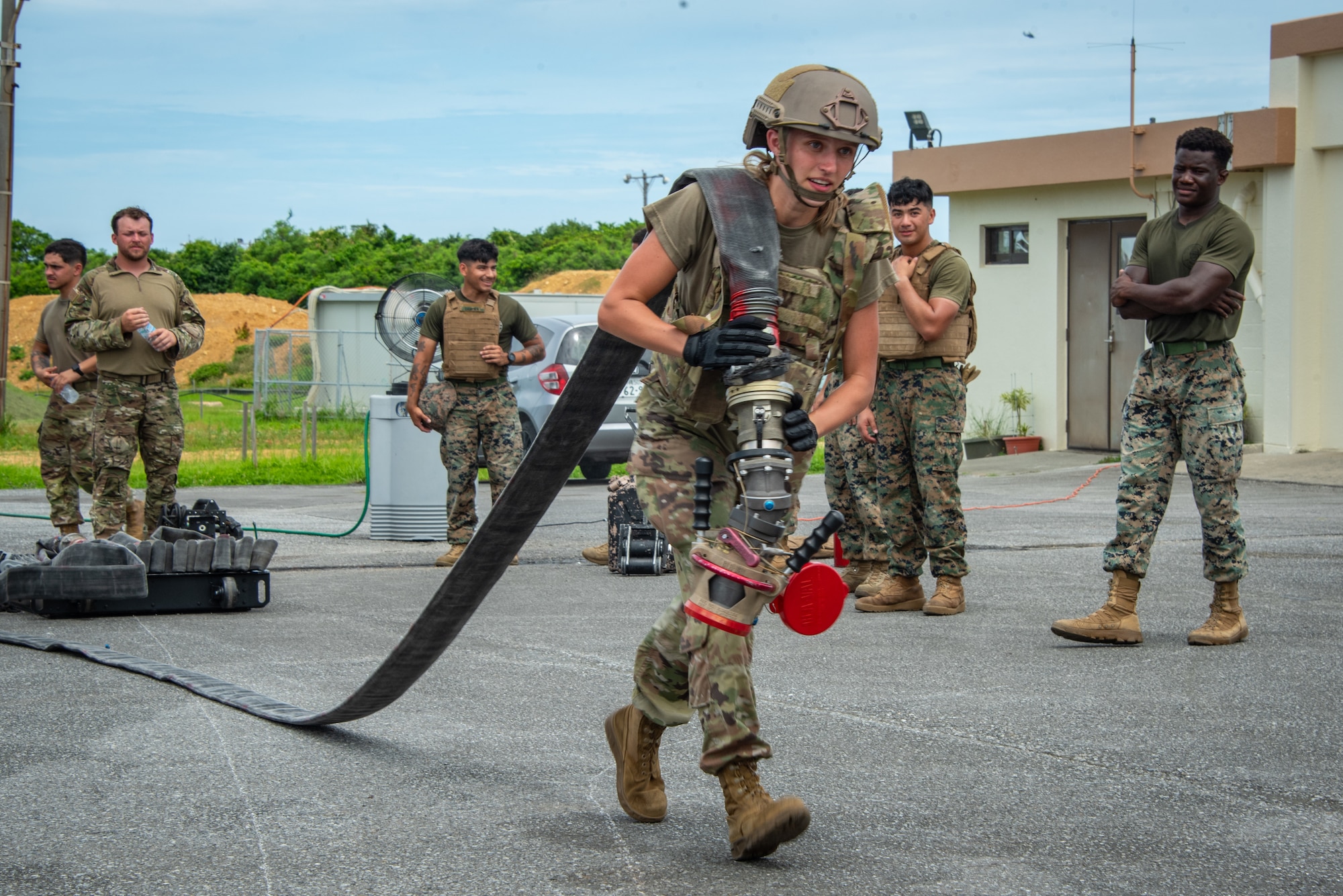 U.S. Air National Guard Staff Sgt. Sterling Morgan, 134th Logistics Readiness Squadron, pulls a fuel hose during a joint Forward Arming and Refueling Point training event at Kadena Air Base, Japan, June 18, 2025. These refueling missions replicate deployed scenarios, emphasizing speed, coordination, and operational security. (U.S. Air National Guard photo by Staff Sgt. Jesse Hanson)