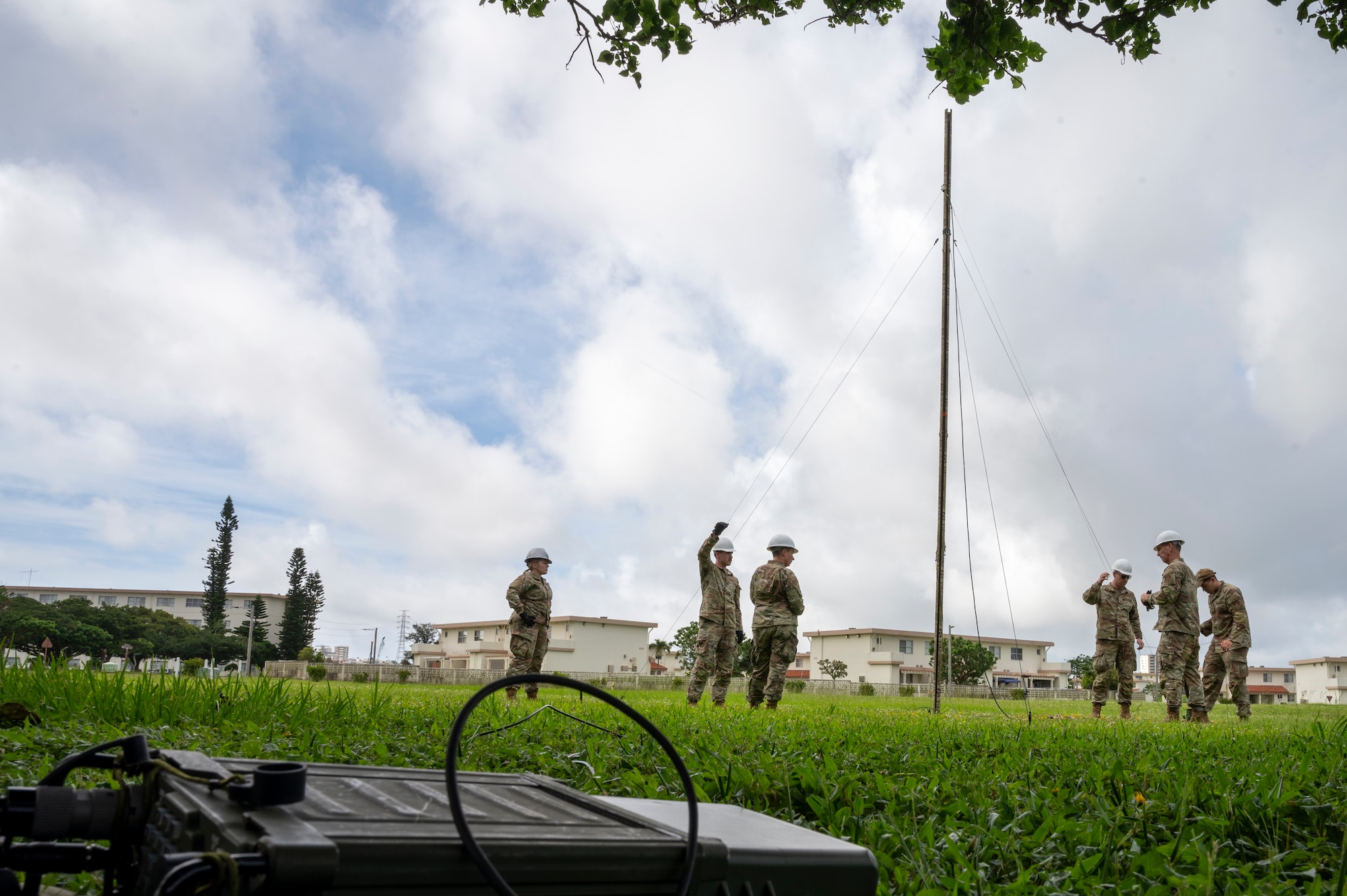 U.S. Air National Guardsmen assigned to the 134th Communications Squadron, assist Airmen assigned to the 18th Communications Squadron, during the setup of a Rolatube Integrated Antenna Mast-Deployable or rapid deployment antenna at Kadena Air Base, Okinawa, Japan, June 13, 2025. This system increased operational agility worldwide by providing communication capabilities in areas without sustainable infrastructure. (U.S. Air National Guard Photo by Staff Sgt. Brandon Keys)