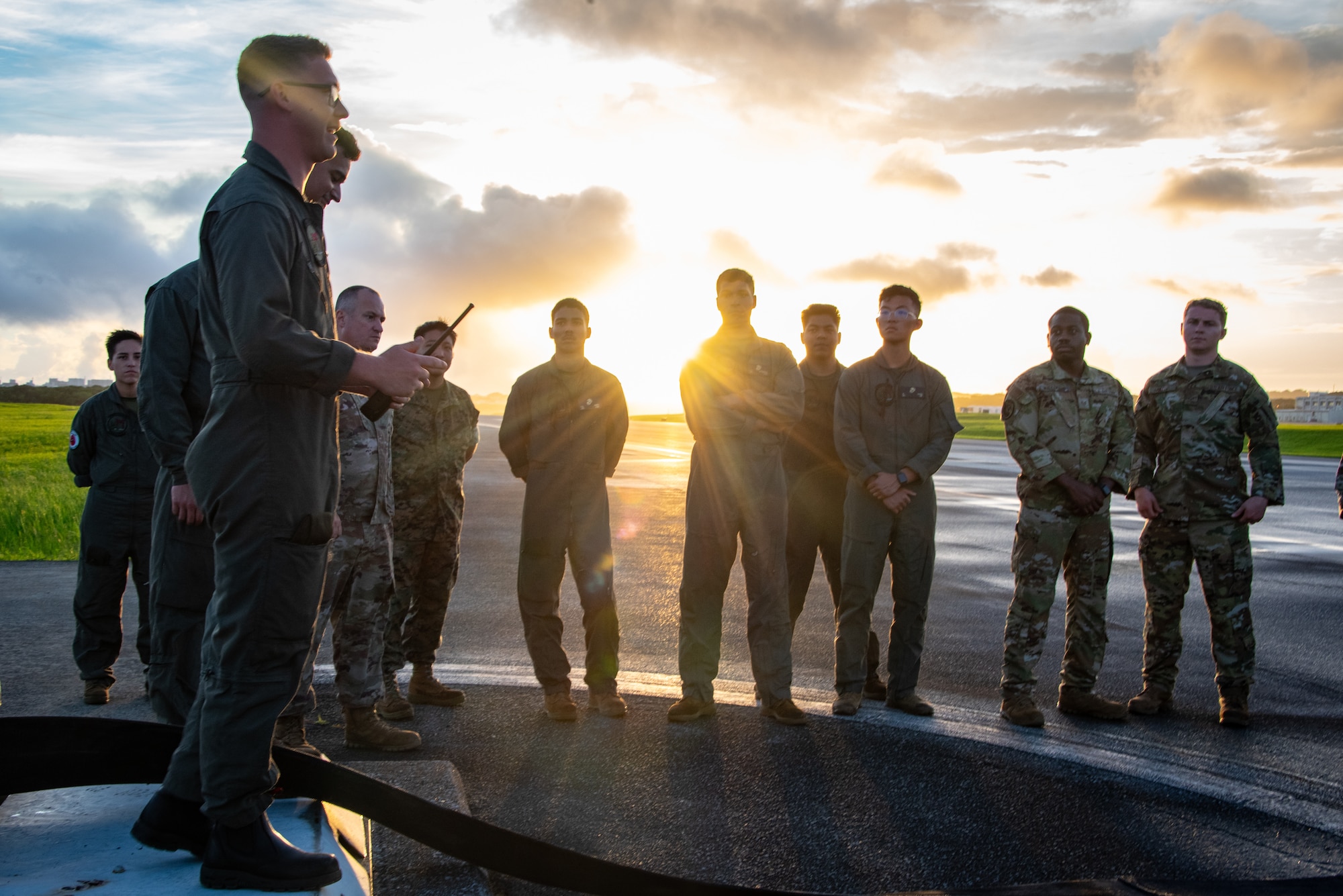 U.S. Marines assigned to the Headquarters and Headquarters Squadron, Marine Corps Air Station Futenma, and Air National Guard Airmen assigned to the 134th Civil Engineer Squadron, discuss the Barrier Arresting Kit-12 during a joint BAK-12 inspection training exercise at MCAS Futenma, Japan, June 13, 2025. Training like this enhances joint emergency response readiness and supports interoperability between Marine Corps and Air National Guard forces operating in the Indo-Pacific region. (U.S. Air National Guard photo by Staff Sgt. Jesse Hanson)