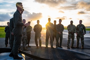 U.S. Marines assigned to the Headquarters and Headquarters Squadron, Marine Corps Air Station Futenma, and Air National Guard Airmen assigned to the 134th Civil Engineer Squadron, discuss the Barrier Arresting Kit-12 during a joint BAK-12 inspection training exercise at MCAS Futenma, Japan, June 13, 2025. Training like this enhances joint emergency response readiness and supports interoperability between Marine Corps and Air National Guard forces operating in the Indo-Pacific region. (U.S. Air National Guard photo by Staff Sgt. Jesse Hanson)