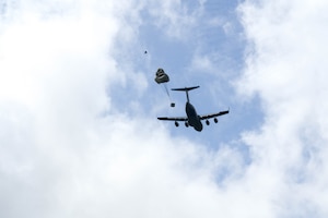 A U.S. Air Force C-17 Globemaster III drops cargo over a drop zone on Oahu, Hawaii.