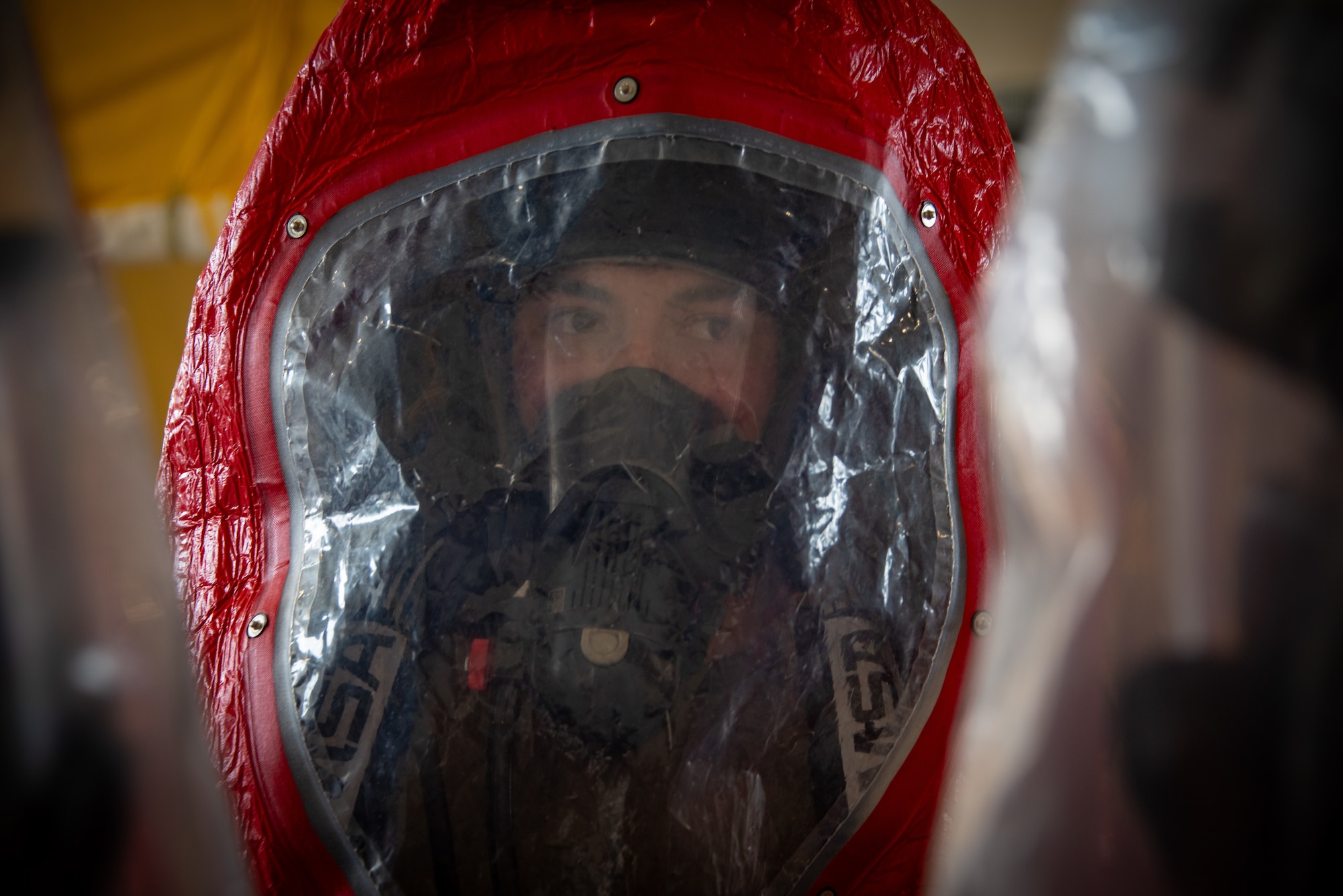 Airman 1st Class Nicholas Garcia, 18th Civil Engineer Squadron, fire and emergency services, wears a hazardous materials suit during a recertification course at Kadena Air Base, Japan, June 18, 2025. The suit provides protection during simulated chemical exposure scenarios to ensure readiness for real-world incidents. (U.S. Air National Guard photo by Staff Sgt. Jesse Hanson)