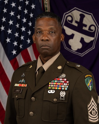 CSM Carlton Jones poses for his command photo in front of the flag of the United States of America and the flag of the 352nd Civil Affairs Command