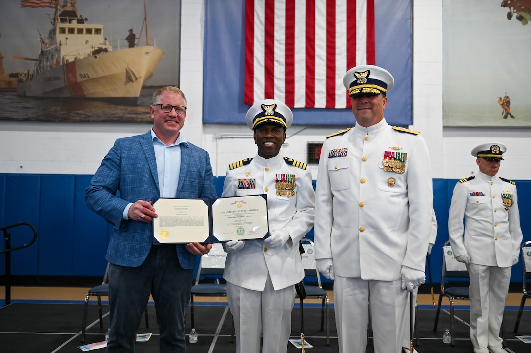 U.S. Coast Guard Capt. Amanda Lee relieved Capt. Warren Judge as Commanding Officer, Training Center Cape May, during an official ceremony on June 24, 2022, in the William Flores Gymnasium at Training Center Cape May, N.J. The change of command ceremony is a time-honored tradition that represents a total transfer of responsibility, authority, and accountability from one officer to another. (U.S. Coast Guard photo by Petty Officer 2nd Class Gregory Schell)