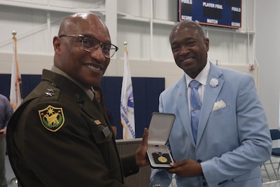 Maj. Gen. Rodney Boyd, the Adjutant General of Illinois and Commander of the Illinois National Guard, awards the Illinois Distinguished Service Medal to Col. (retired) Maurice Rochelle
