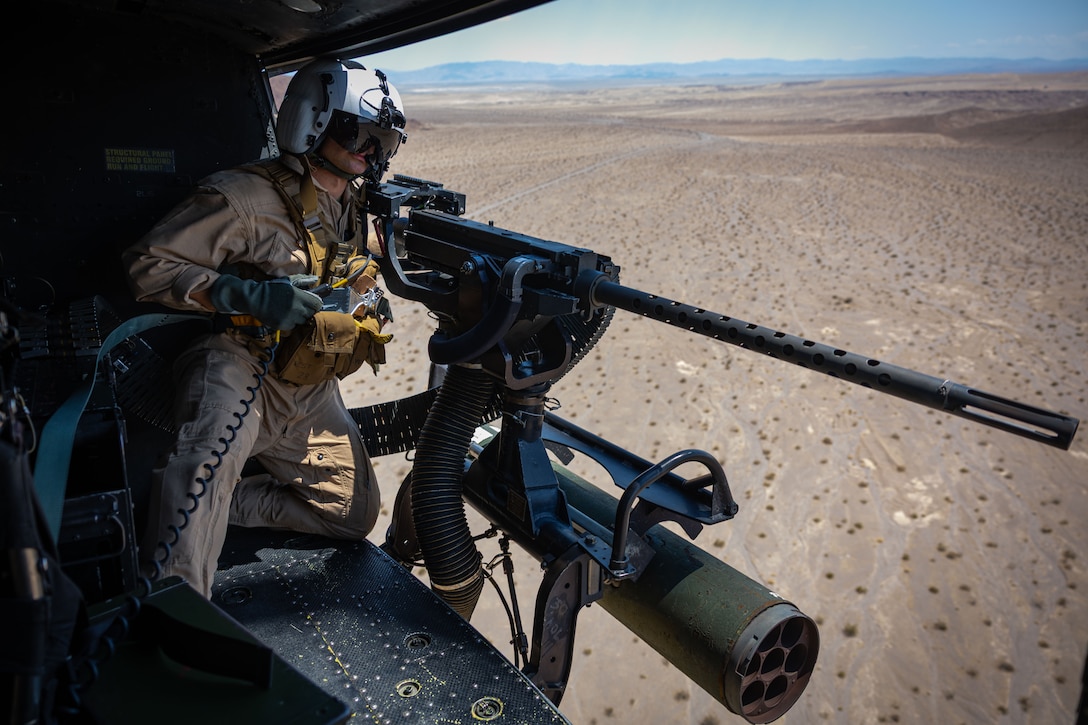 U.S. Marine Corps Lance Cpl. Kenneth Bonura, a Louisiana native, UH-1Y Huey helicopter crew chief with Marine Light Attack Helicopter Squadron (HMLA) 773, Marine Aircraft Group 29, posts security with a M2 .50 Cal. machine gun during Integrated Training Exercise 3-25 at Marine Corps Air Ground Combat Center, Twentynine Palms, California, June 6, 2025. MCAGCC serves as the Marine Corps’ premier training venue for service-level training exercises by providing a realistic multi-domain environments to prepare forces for success in future conflicts. (U.S. Marine Corps photo by Sgt. Makayla Elizalde)