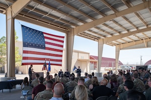 Airmen and guests listen as George Tinseth, 355th Wing historian, delivers a speech highlighting the history and accomplishments of the 58th Rescue Squadron (RQS) during its inactivation ceremony at Nellis Air Force Base, Nevada, June 17, 2025.