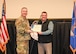 Military members and civilians interact during an honorary commander induction ceremony.
