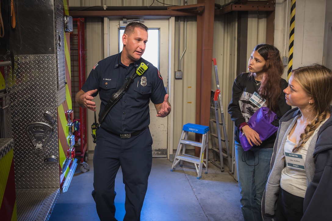 Colin McClay, a California native, fire inspector with the Combat Center Fire Department, speaks to Morongo Unified School District students during a MUSD Job Shadow event at MCAGCC, Twentynine Palms, California, March 18, 2025. The Job Shadowing program was established over 18 years ago to showcase careers available at MCAGCC by pairing students with their specifically requested careers and the subject matter experts. (U.S. Marine Corps photo by Cpl. Damian Oso)