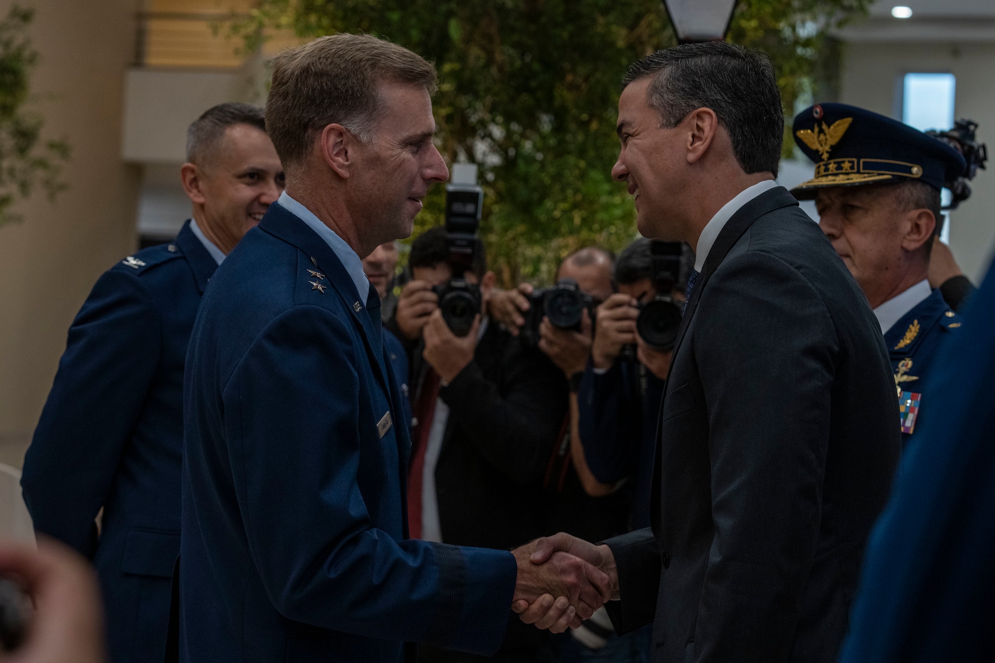 U.S. Air Force Maj. Gen. David Mineau, Air Forces Southern commander, (left), and Santiago Peña, President of the Republic of Paraguay, shake hands during the 65th Conference of the American Air Chiefs meeting in Asuncion, Paraguay, June 18, 2025. The relationships forged during CONJEFAMER serve as the foundation for stronger cooperation, enabling air forces across the Americas to respond more effectively to shared challenges and humanitarian crises. (U.S. Air Force photo by Andrea Jenkins)