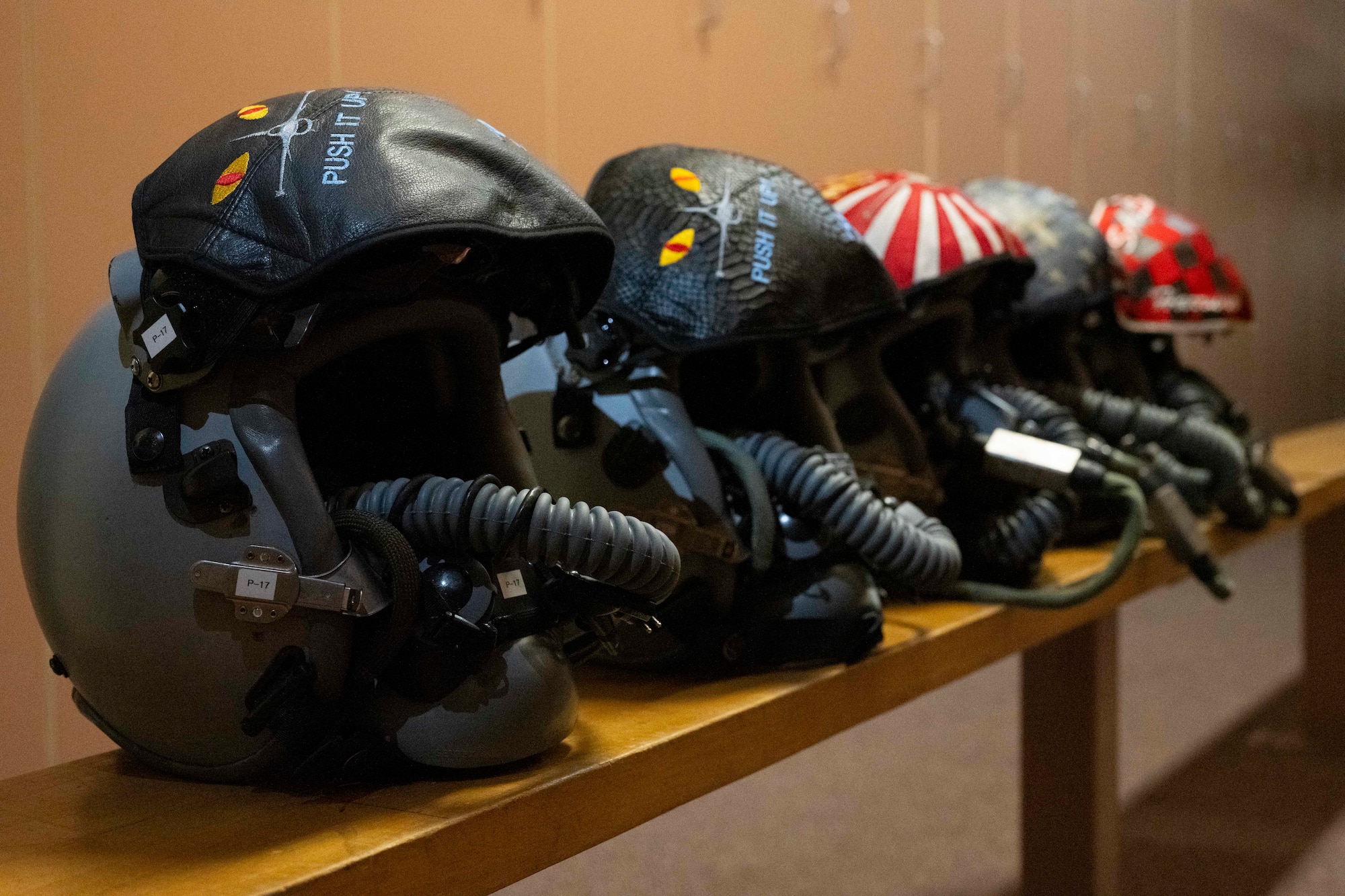 F-16 Fighting Falcon helmets lay on a bench in the Aircrew Flight Equipment office during Red Flag-Alaska 25-2 at Eielson Air Force Base, Alaska, June 16, 2025.