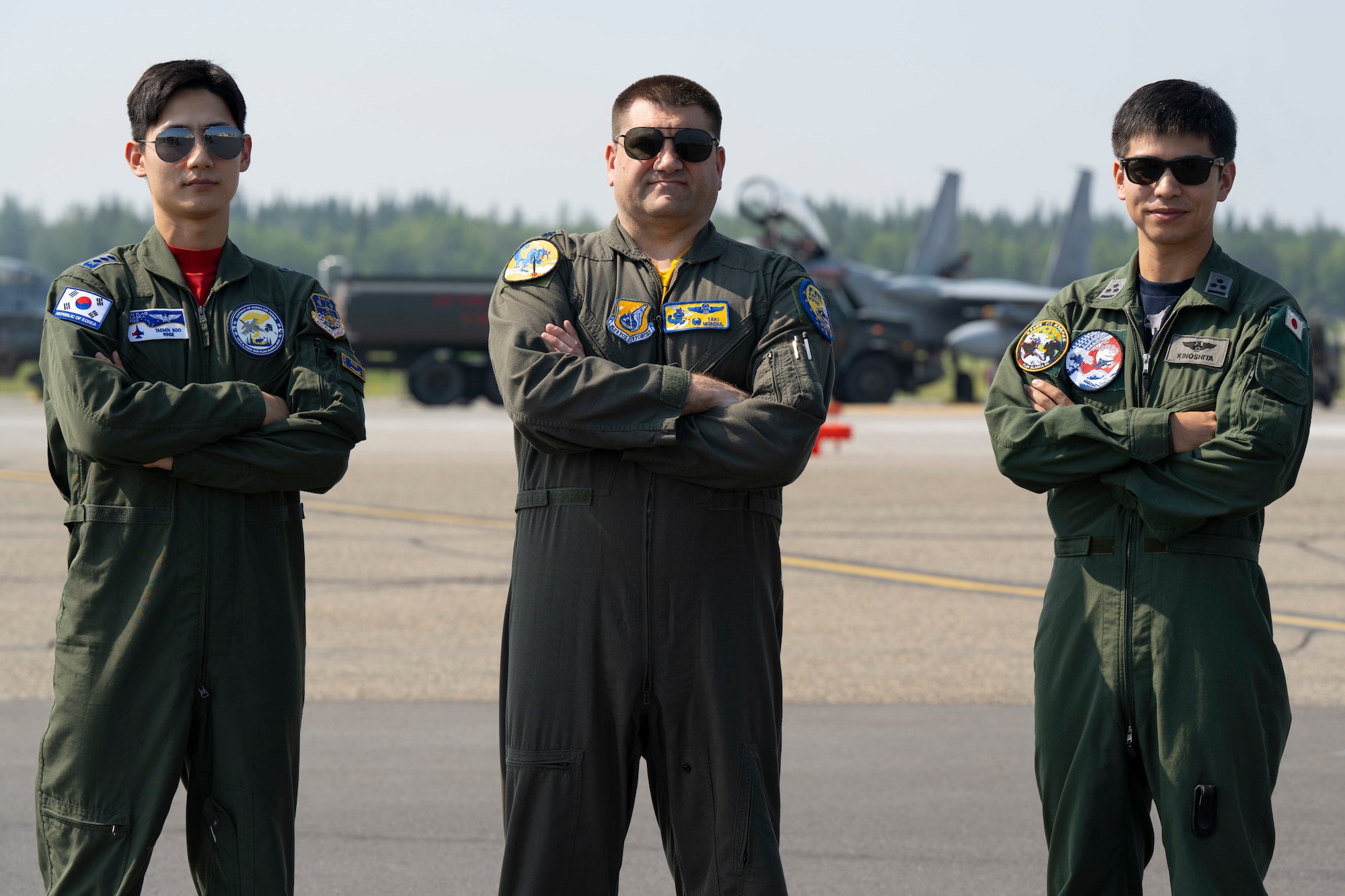 Republic of Korea Air Force Capt. Taemin Koo, left, F-16 pilot, U.S. Air Force Lt. Col. Nathan “Yaki” Mondul, center, 18th Fighter Interceptor Squadron commander, and a Japan Air Self-Defense Force F-15 pilot, pose for a photo during Red Flag-Alaska 25-2 at Eielson Air Force Base, Alaska, June 20, 2025.