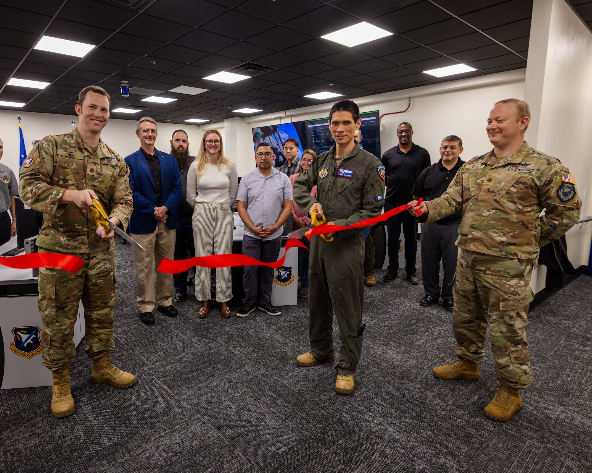 Lt. Col. Brian Reis, Air Force Test Pilot School director of space operations, and Col. James Valpiani, then TPS commandant, cut the ribbon to officially open the Satellite Operations Center (SOC) at Edwards Air Force Base, California, June 11. (Air Force photo by Brandon Hernandez)