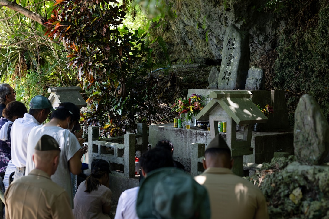 U.S. Marines and locals pay their respects at the Hamahiga Island memorial site on Hamahiga Island, Okinawa, Japan, June 23, 2025. The first memorial is dedicated to the island residents who lost their lives during the battle, while the second memorial recognizes U.S. Marine Corps Col. Kermit Shelly, who was the commanding officer of 3rd Force Service Regiment from March 1967 until his death in June 1968. Shelly had a profound impact on the restoration of the local community and his most notable efforts include the construction of an elementary school, middle school, church, community hall, multiple private residences and the island’s water reservoir. (U.S. Marine Corps photo by Cpl. Jesse Davis)