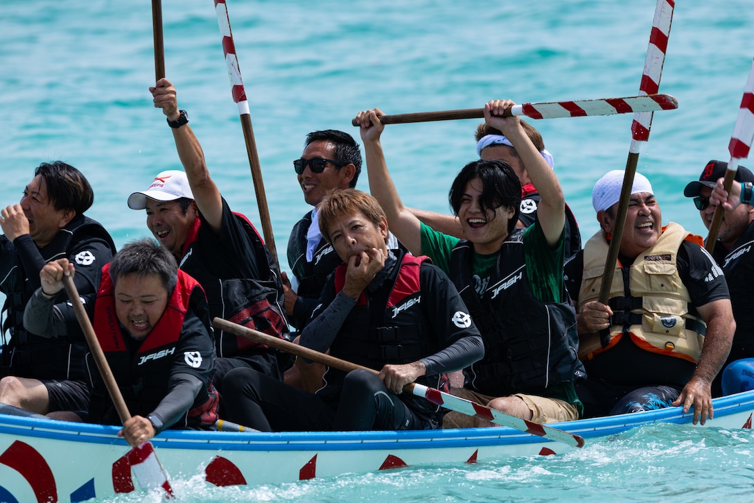 A local team competes in a dragon boat race in Kin Town, Okinawa, Japan, June 1, 2025. Over 15 Teams comprised of locals, U.S service members and status of forces agreement personnel participated in the dragon boat race. The dragon boat race consists of three teams per match, and 11 members per team. (U.S. Marine Corps photo by Lance Cpl. Brody Robertson)