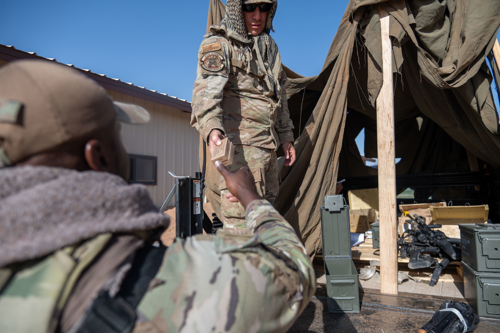 Airmen assigned to the 23d Air Task Force distribute blank ammunition to prepare for base defense tactics during an expeditionary skills exercise at Fort Bliss, Texas, June 16, 2025.