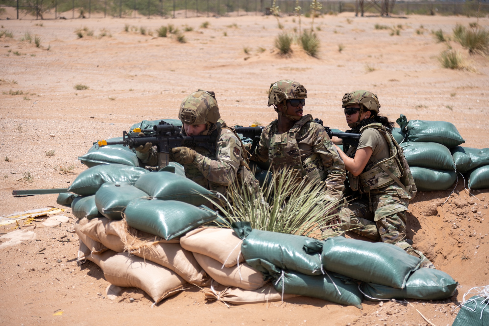 Airmen assigned to the 23d Air Task Force return fire with blank ammunition at simulated enemies during a base defense demonstration as part of an expeditionary skills exercise at Fort Bliss, Texas, June 16, 2025