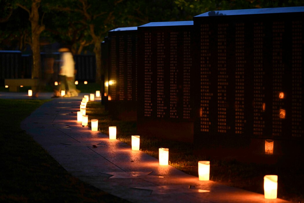Candles lit by local volunteers and U.S. Navy Sailors stationed on Okinawa illuminate memorial walls following a volunteer candle lighting event at Peace Memorial Park in Itoman, Okinawa, Japan, June 22, 2025.