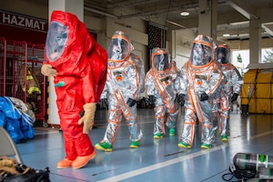 Airman 1st Class Nicholas Garcia, 18th Civil Engineer Squadron, fire and emergency services, leads a group during a joint hazardous materials recertification course at Kadena Air Base, Japan, June 18, 2025. The group also includes U.S. Marines assigned to Camp Foster and Air National Guardsmen assigned to the 134th Civil Engineer Squadron. The exercise fostered interoperability across active-duty, Guard, and Marine Corps emergency response teams. (U.S. Air National Guard photo by Staff Sgt. Jesse Hanson)
