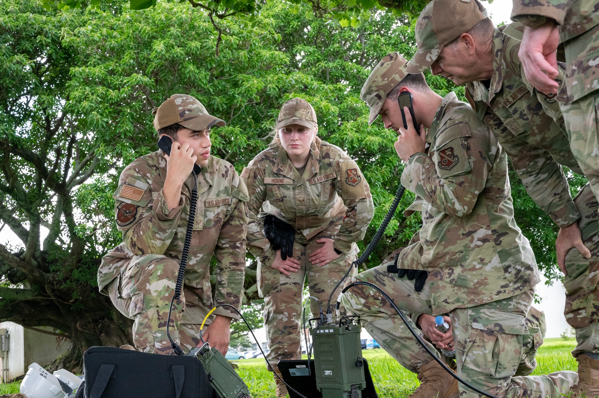 U.S. Air National Guardsmen Airmen assigned to the 134th Communications Squadron, and Airmen assigned to the 18th Communications Squadron, check radio communication lines at Kadena Air Base, Okinawa, Japan, June 13, 2025. These radio checks foster the clear transfer of information and improve cohesion and synergy between assets inside the Indo-Pacific Command. (U.S. Air National Guard Photo by Staff Sgt. Brandon Keys)
