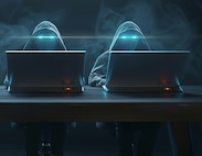 AI image of two hooded individuals sitting behind laptops.