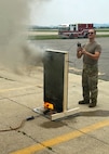 U.S. Air Force Staff Sgt. Adam Carroll, 51st Civil Engineer Squadron firefighter, measures the temperature of a fire behavior demonstrator during Osan’s first bilingual InSource Consulting Fire Training at Osan Air Base, Republic of Korea, June 18, 2025. The course was conducted in both English and Korean, with a live translator to help ensure key concepts were clearly communicated. (U.S. Air Force photo by Staff Sgt. Sarah Williams)