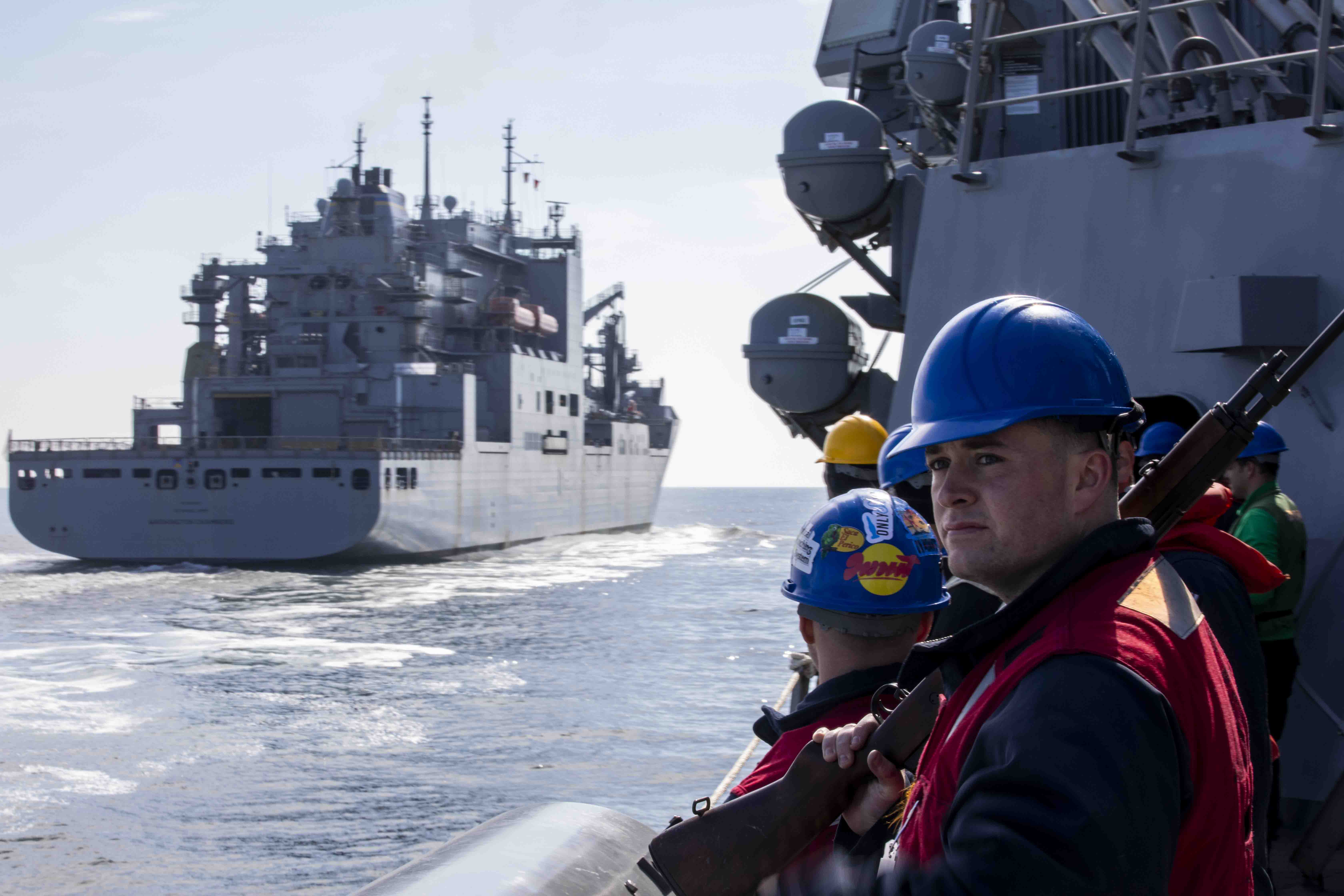 Sailors assigned to the Arleigh Burke-class guided-missile destroyer USS Preble (DDG 88) stand by for an underway replenishment as the ship pulls alongside USNS Washington Chambers (T-AKE-11) in the North Pacific Ocean, June 21. The Preble is forward deployed and assigned to Destroyer Squadron (DESRON) 15, the Navy’s largest DESRON and the U.S. 7th fleet’s principal surface force. (U.S. Navy photo by Mass Communication Specialist 1st Class Jamaal Liddell)
