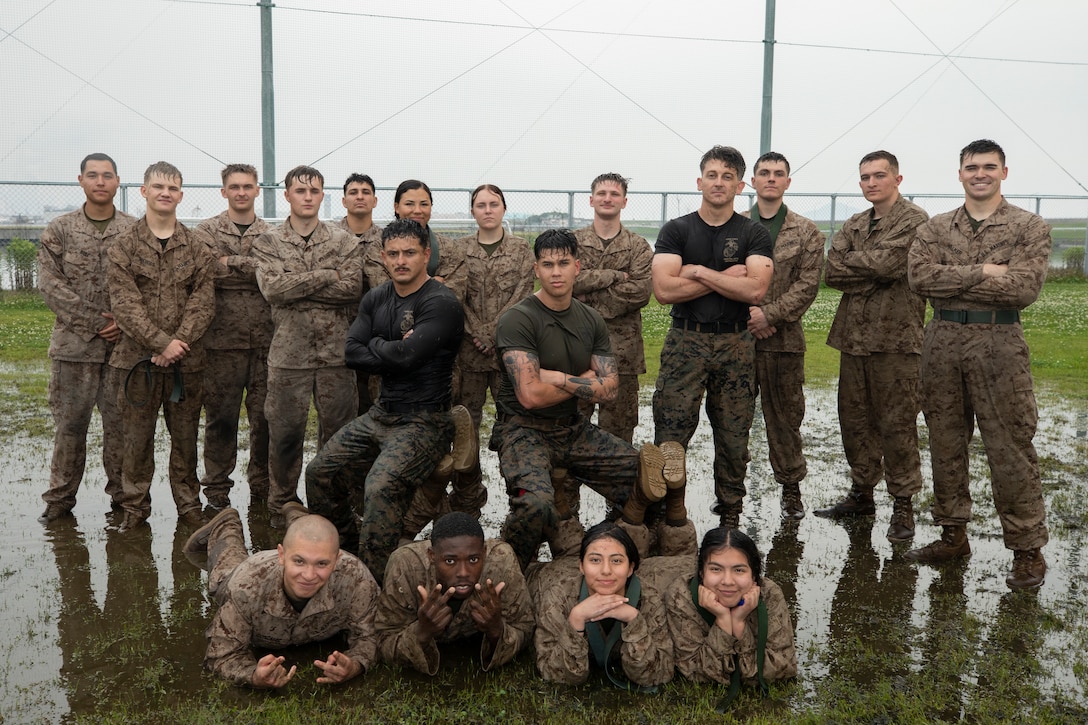 U.S. Marines with Headquarters and Headquarters Squadron, Marine Corps Air Station Iwakuni, pose for a group photo during a Marine Corps Martial Arts Program belt advancement course at MCAS Iwakuni, Japan, June 12, 2025.  MCMAP training integrates close-quarters combat techniques with warrior ethos studies and instruction. (U.S. Marine Corps photo by Lance Cpl. Isaac De Leon)
