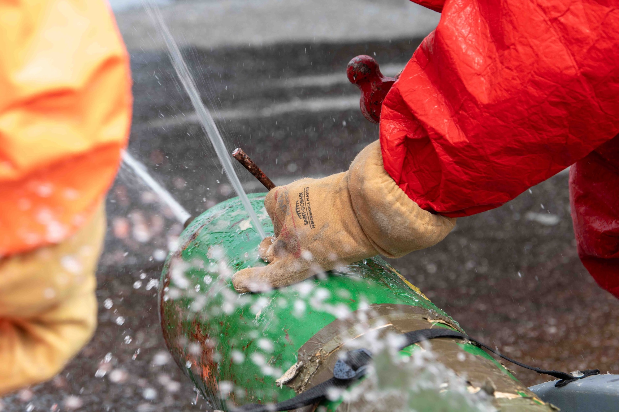 service members use tools to stop leak
