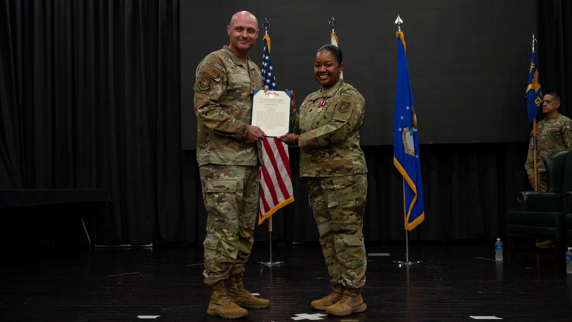 U.S. Air Force Lt. Col. Annabelle Hill, right,  outgoing 51st Force Support Squadron commander, receives the Meritorious Service Medal from Col. Jeff Elliott, 51st Mission Support Group commander, during a Change of Command ceremony at Osan Air Base, Republic of Korea, June 24, 2025. Hill led the Wing’s largest multi-capable squadron of nearly 900 Airmen across nine flights, multiple business operations and programs. (U.S. Air Force photo by Senior Airman Rome Bowermaster)