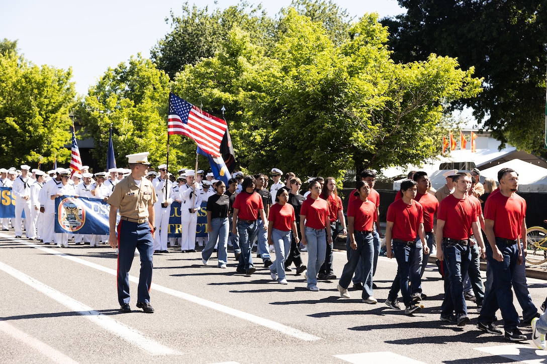 U.S. Marine Corps Maj. Brian Berling, commanding officer, and poolees, all with Recruiting Station Portland, march in the Grand Floral Parade during Portland Fleet Week in Portland, Oregon, June 7, 2025. Portland Fleet Week is a time-honored celebration of the sea services and provides an opportunity for the citizens of Oregon to meet Sailors, Marines, and Coast Guardsmen, as well as witness firsthand the latest capabilities of today’s maritime services. (U.S. Marine Corps photo by Sgt. Andrew Bray)