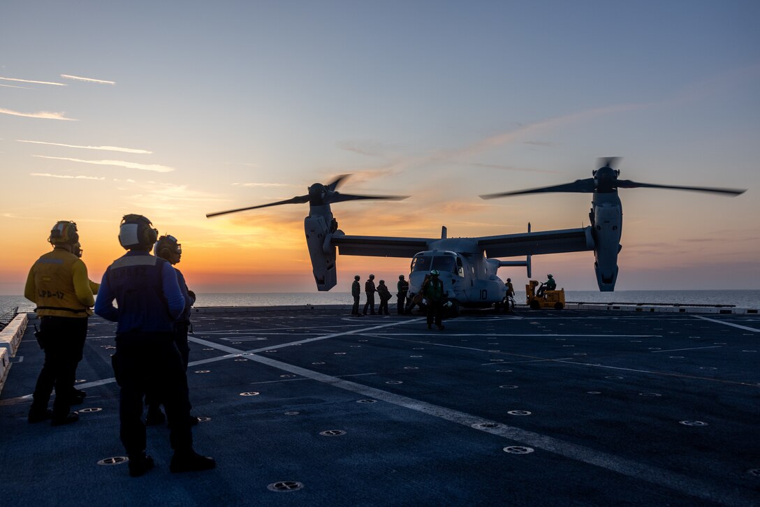 U.S. Marines with Marine Medium Tiltrotor Squadron 263 (Reinforced), 22nd Marine Expeditionary Unit (Special Operations Capable), unload supplies from a MV-22B Osprey, while conducting flight operations during Composite Training Unit Exercise, aboard the San Antonio-class amphibious transport dock ship USS San Antonio (LPD 17), Iwo Jima Amphibious Ready Group, while underway in the Atlantic Ocean, June 22, 2025. During COMPTUEX, the IWOARG and 22nd MEU (SOC) refine tactics, techniques, and procedures to execute warfighting functions that enhance operational readiness and lethality as a unified IWOARG/22 MEU (SOC) team. (U.S. Marine Corps photo by Lance Cpl. Kyle Baskin)