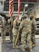 The commander of the 405th Army Field Support Brigade, Col. Ernest Lane II, passes the AFSBn-Poland colors to the incoming commander, Lt. Col. Michelle McDevitt, during the AFSBn-Poland change of command ceremony June 25, 2025, at the Powidz Army Prepositioned Stocks-2 worksite.