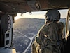 U.S. Army Reserve Spc. Shavaun Brugger, a UH-60 helicopter repairer assigned to Charlie Company, 7th Battalion, 158th Aviation Regiment, peers out of the door of a Black Hawk during Mojave Falcon 2025 at Fort Hunter Liggett, California, June 8, 2025. Mojave Falcon 2025 is a multi-faceted first-of-its-kind Army Reserve training exercise that integrates Combat Support Training Exercise (CSTX), Global Medic, Quartermaster Liquid Logistics Exercise (QLLEX), Port Operations and Nationwide Move. (U.S. Army photo by Staff Sgt. Mikayla Fritz)