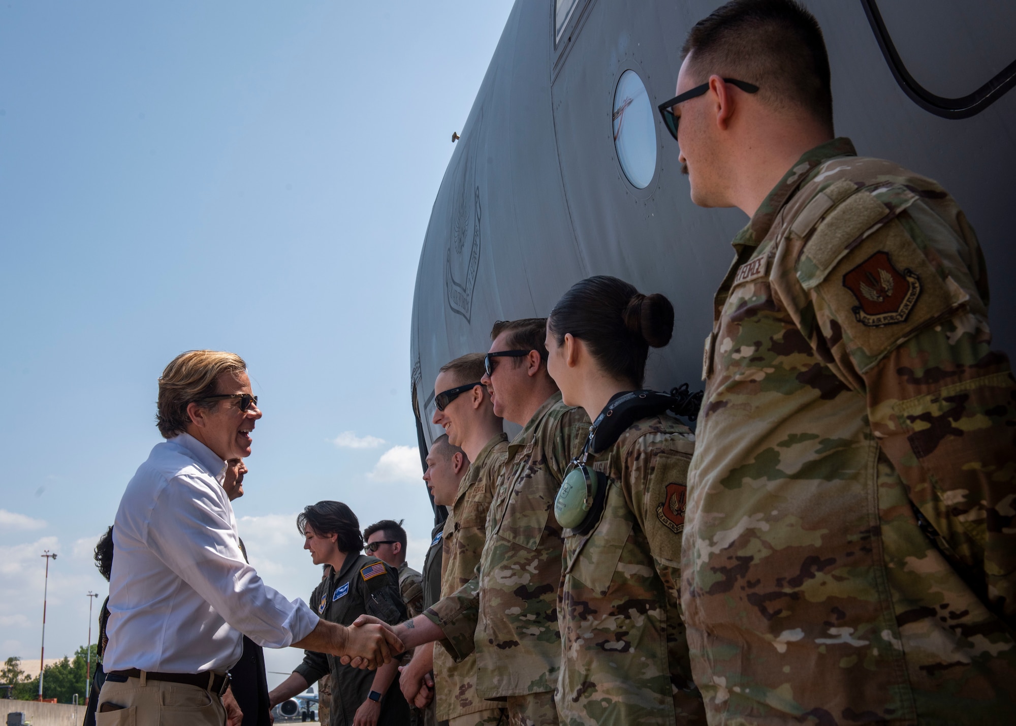 Representatives shake Airmen's hands.