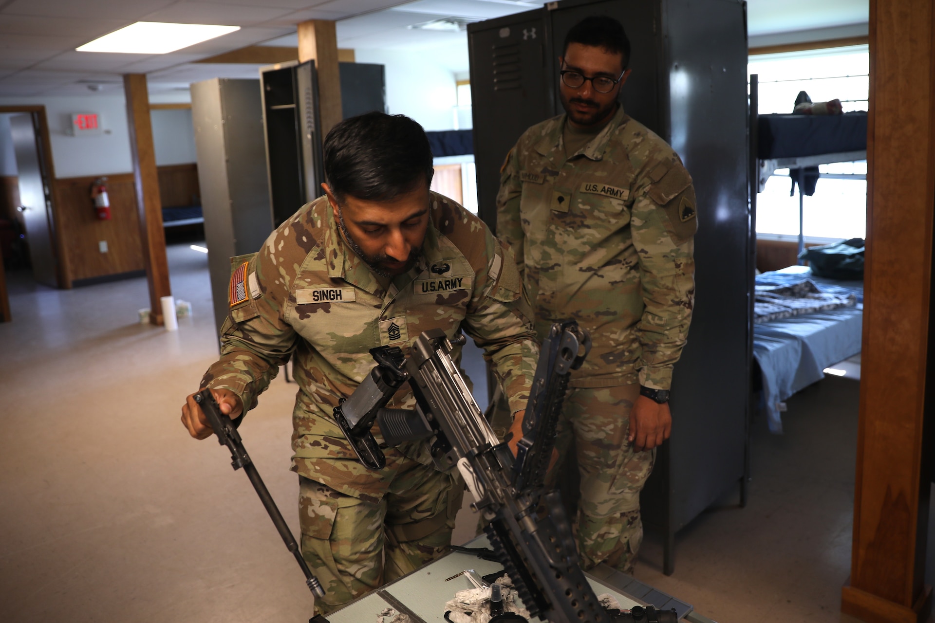 U.S. Army 1st Sgt. Sahib Singh and Spc. Islam Mahmoud, financial management technicians with the 1946th Finance Company, examine a weapons system on Fort Indiantown Gap, Pa., June 11, 2025. The 1946th did extensive firearm and maintenance and marksmanship training as part of their annual training. (U.S. Army Photo by Spc. Carrol Hughes)