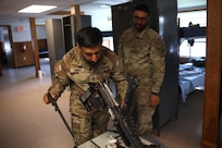 U.S. Army 1st Sgt. Sahib Singh and Spc. Islam Mahmoud, financial management technicians with the 1946th Finance Company, examine a weapons system on Fort Indiantown Gap, Pa., June 11, 2025. The 1946th did extensive firearm and maintenance and marksmanship training as part of their annual training. (U.S. Army Photo by Spc. Carrol Hughes)